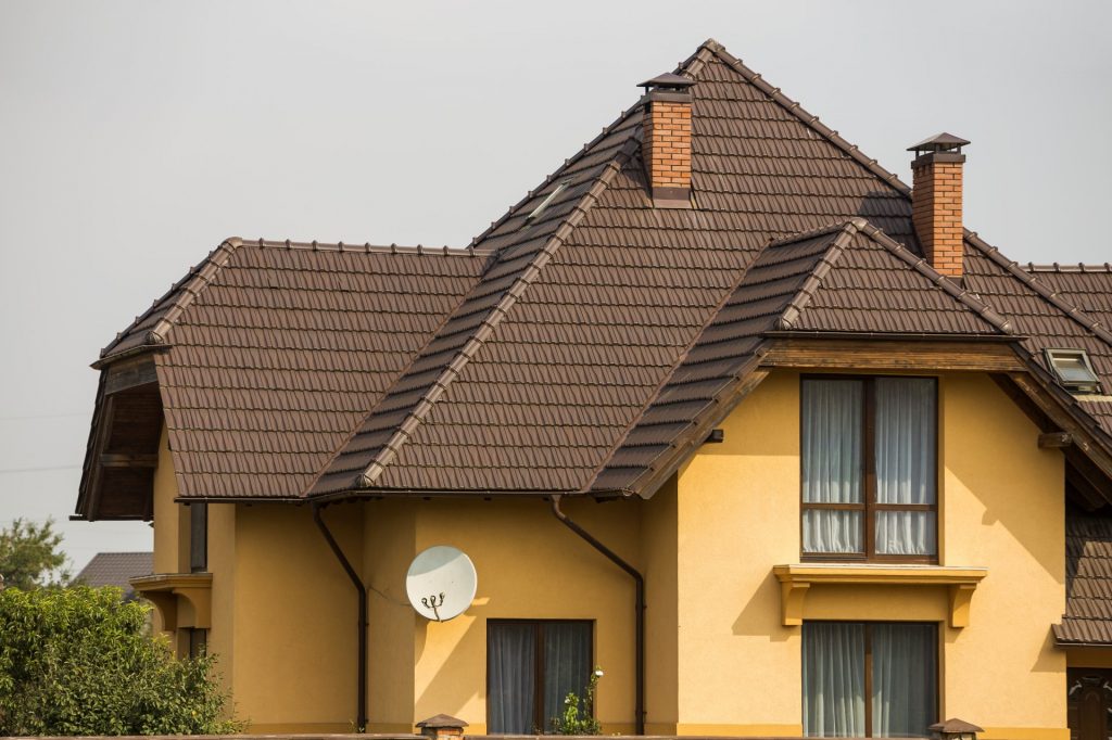 residential-house-with-shingled-brown-roof-high-brick-photo.jpg