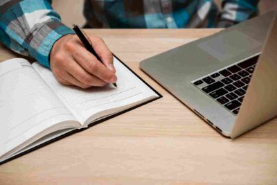 business-man-writing-blank-notebook_11zon.jpg
